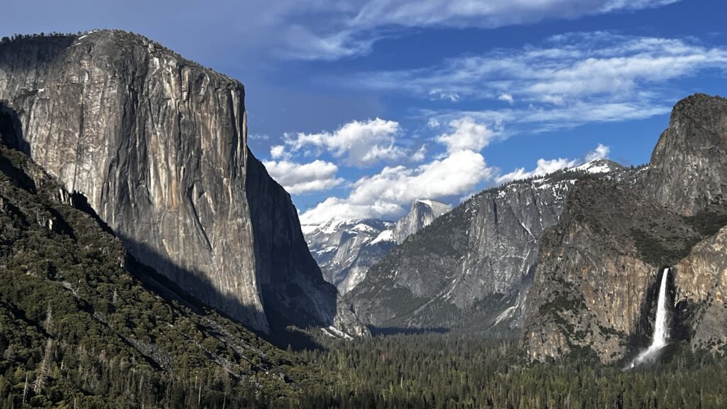 Photo showing a magnificent view of Yosemite Valley with towering cliffs and waterfalls.  This article will reveal many family friendly activities in Yosemite Valley. 