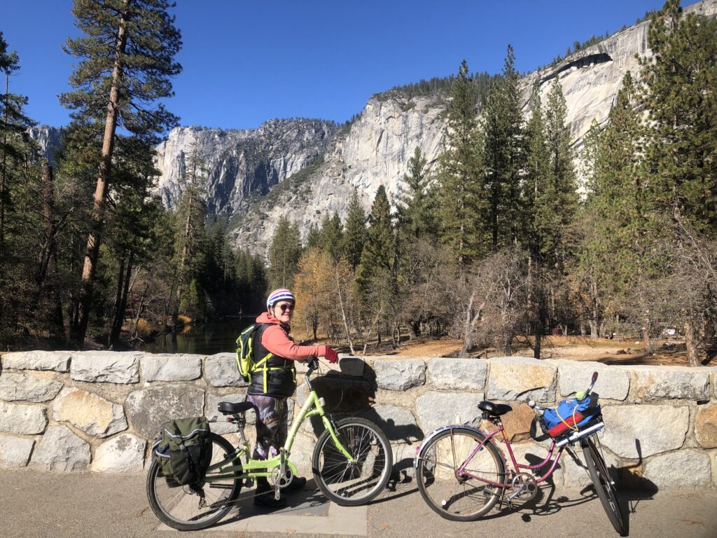 Cyclist stops along the bicycle path to see the amazing view of the cliffs surrounding Yosemite Valley.